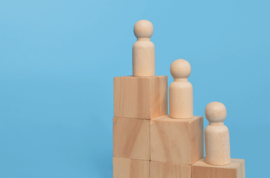 Wooden figures on stacked blocks