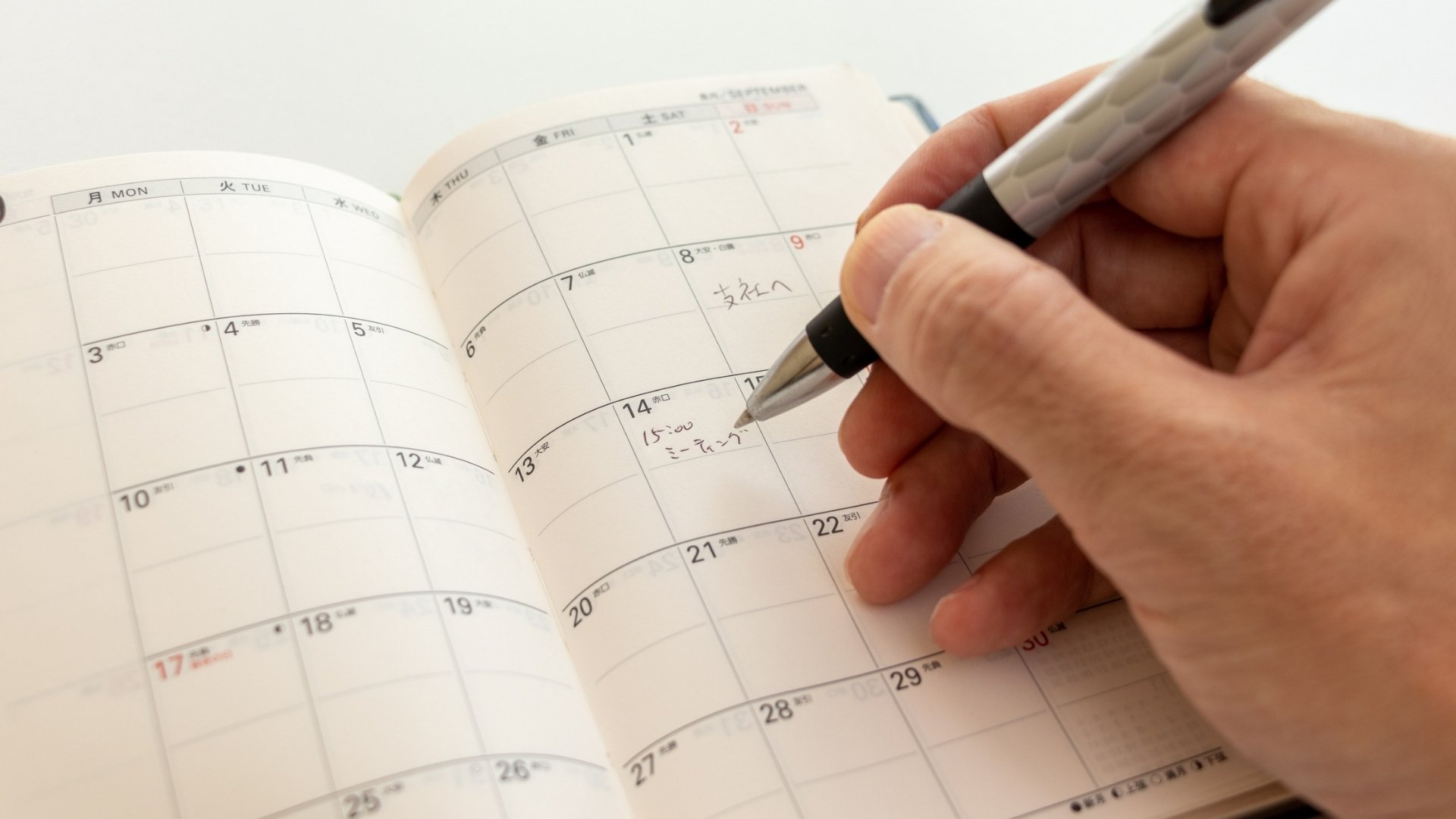 writing notes into a calendar notebook